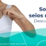 Imagem mostrando uma mulher tirando uma prótese de silicone de dentro da blusa dela, no qual tem um cifrão no meio da prótese